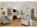 Bright living room with hardwood floors, fireplace, built-in shelving, and ample seating at 535 Cameron Manor Way, Atlanta, GA 30328