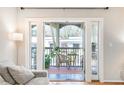 View from the open French doors to the exterior balcony with outdoor seating and potted plants at 1445 Monroe Ne Dr # G3, Atlanta, GA 30324
