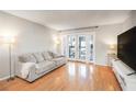 Bright living room features hardwood floors and sliding glass doors to the outdoor balcony area at 1445 Monroe Ne Dr # G3, Atlanta, GA 30324