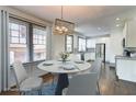 Dining room features a modern light fixture and view into kitchen with stainless steel appliances at 1497 Rogers Sw Ave, Atlanta, GA 30310