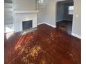 Inviting living room with hardwood floors, a brick fireplace, and built-in shelving at 3426 Glenwood Rd, Decatur, GA 30032