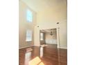 Spacious living room with hardwood floors and elegant light fixtures at 1172 Preserve Park Dr, Loganville, GA 30052