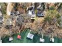Overhead shot of lakeside homes with private docks, showcasing the neighborhood's access to water activities at 7410 Fields Dr, Cumming, GA 30041