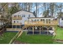 Multi-level deck and spacious backyard, ideal for outdoor entertaining and relaxation, with lush green grass at 7410 Fields Dr, Cumming, GA 30041