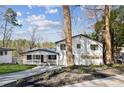 Beautifully landscaped two-story home featuring a charming front porch and an attached two car garage at 7410 Fields Dr, Cumming, GA 30041
