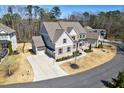 Beautifully designed home features a large driveway, three-car garage and a meticulously maintained lawn at 1775 Rockwater Rd, Marietta, GA 30066