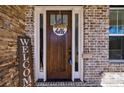 Inviting front door adorned with a wreath and welcome sign, set against a brick facade at 1775 Rockwater Rd, Marietta, GA 30066