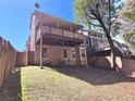 Back exterior featuring a wooden fence, lush lawn, and a partially covered deck, perfect for outdoor living at 2270 Goodwood Se Blvd, Smyrna, GA 30080