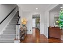 Inviting foyer with hardwood floors and staircase with black banister, providing a grand entrance to the home at 3471 Greyfield Nw Ln, Kennesaw, GA 30152
