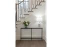 Close up of staircase detailing the modern railings, hardwood treads, and stylish decor at 56 Pine St, Roswell, GA 30075