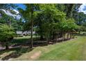 Well-manicured front lawn and landscaping leading up to a quaint home at 59 Woodlawn Dr, Marietta, GA 30067