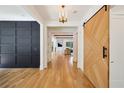 Elegant home foyer with hardwood floors and stylish barn door at 159 E Wesley Ne Rd, Atlanta, GA 30305