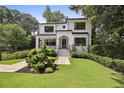 Beautifully landscaped front yard of a two-story home with a stone walkway at 159 E Wesley Ne Rd, Atlanta, GA 30305