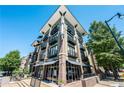 Modern building exterior with balconies and street-level retail space at 5300 Peachtree Rd # 503, Atlanta, GA 30341