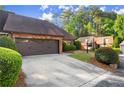 Brick home featuring an attached two car garage and mature landscaping in the front yard at 6 Westchester Sq, Decatur, GA 30030