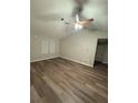 Well-lit living room with vaulted ceilings, wooden floors, and neutral color palette at 9161 Fairway Ct, Riverdale, GA 30274