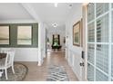 Inviting home foyer featuring beautiful flooring, art, and natural light from the front door at 106 Asher Dr, Carrollton, GA 30116
