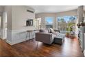 Open concept living space with hardwood flooring, stylish seating, and large windows at 1 Biscayne Nw Dr # 211, Atlanta, GA 30309