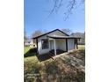 Quaint home with a covered back entrance and surrounding yard at 5160 Avery St, Covington, GA 30014
