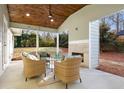 Relaxing back porch with a wood ceiling, a stylish fireplace, and outdoor seating at 1020 Pinedale Se Dr, Smyrna, GA 30080
