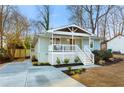 Stylish exterior showcasing the home's modern porch, new landscaping, and freshly poured concrete driveway at 1020 Pinedale Se Dr, Smyrna, GA 30080
