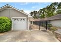 Garage exterior featuring a white garage door, and black fence to the entry way of the house at 1126 Berkley Se Dr, Smyrna, GA 30082