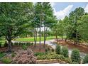 Overlooking the golf course, this property boasts lush greenery and mature trees at 3299 Carmichael Pl, Duluth, GA 30097