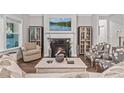 Cozy living room featuring a fireplace, comfortable seating, and elegant decor at 2638 Songbird Ln, Grayson, GA 30017