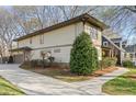 Side view of home featuring a long driveway, manicured lawn and landscaping at 2011 Braeburn Se Cir, Atlanta, GA 30316