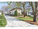 View of home with a long driveway and beautifully manicured lawn and landscaping at 2011 Braeburn Se Cir, Atlanta, GA 30316