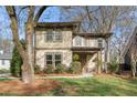Attractive home with a covered front porch and a well-manicured lawn with mature trees at 2011 Braeburn Se Cir, Atlanta, GA 30316