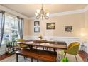 Inviting dining room featuring a wooden table, bench, stylish chairs, and a bright window at 2591 Royston Dr, Duluth, GA 30097