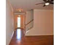 View of staircase with hardwood floors and white trim throughout living room at 3356 Sardis Bend Dr, Buford, GA 30519