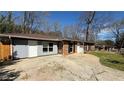 Single-story brick home with a spacious driveway and a mix of brick and siding at 781 E Glochester Pl, Norcross, GA 30071