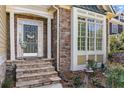 Charming entryway featuring stone steps, a decorative door, and a bright window with beautiful trim at 1463 Bailey Farm Sw Dr, Marietta, GA 30064