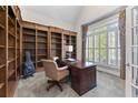 Cozy home office with built-in bookshelves, a classic desk, and natural light from the window at 1463 Bailey Farm Sw Dr, Marietta, GA 30064
