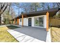 Low angle view of the home showcasing a modern exterior, with a large patio area for outdoor enjoyment at 2047 Boulderview Se Dr, Atlanta, GA 30316