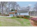 Charming single Gathering home with manicured lawn, brick accents, attached garage, and lovely landscaping at 5995 Lanier Heights Cir, Buford, GA 30518