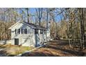 Attractive single-Gathering home with a garage, surrounded by lush greenery, providing a private setting at 2172 Nancy Way, Loganville, GA 30052