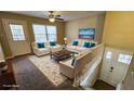 Staged living room with white seating, a decorative rug, and a back deck view for relaxation and entertainment at 2172 Nancy Way, Loganville, GA 30052