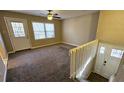 Bright living room with neutral carpet, a ceiling fan, and access to a back deck through a glass door at 2172 Nancy Way, Loganville, GA 30052