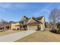 Side view of an attractive two-story house showcasing a long driveway and a well-maintained lawn at 3475 Summerlin Pkwy, Lithia Springs, GA 30122