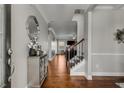Elegant foyer with hardwood floors, decorative mirror, and staircase leading to the upper level at 3475 Summerlin Pkwy, Lithia Springs, GA 30122
