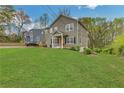 Two story home featuring a manicured lawn, an inviting covered porch, and a well-maintained exterior at 1944 Lakewood Se Ter, Atlanta, GA 30315