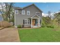 Inviting home with a neatly landscaped lawn, covered entryway, symmetrical windows, and a modern gray exterior at 1944 Lakewood Se Ter, Atlanta, GA 30315