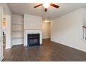 Inviting living room featuring a fireplace, built-in shelving, and hardwood floors at 3879 Brockenhurst Dr, Buford, GA 30519