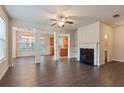 Spacious living area with hardwood floors, fireplace, and open to dining area at 3879 Brockenhurst Dr, Buford, GA 30519
