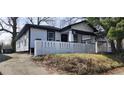 Charming single Gathering home with white siding, black trim and a quaint white fence in front at 884 Thurmond Nw St, Atlanta, GA 30314