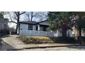 Charming single Gathering home with white siding, black trim and a quaint white fence in front at 884 Thurmond Nw St, Atlanta, GA 30314