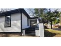Side view of a white house with black trim, black steps and a short white fence at 884 Thurmond Nw St, Atlanta, GA 30314